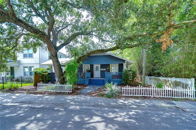 902 W Columbus Dr, Tampa, FL 33602 - view of front of property with covered porch, a fenced front yard, and stucco siding