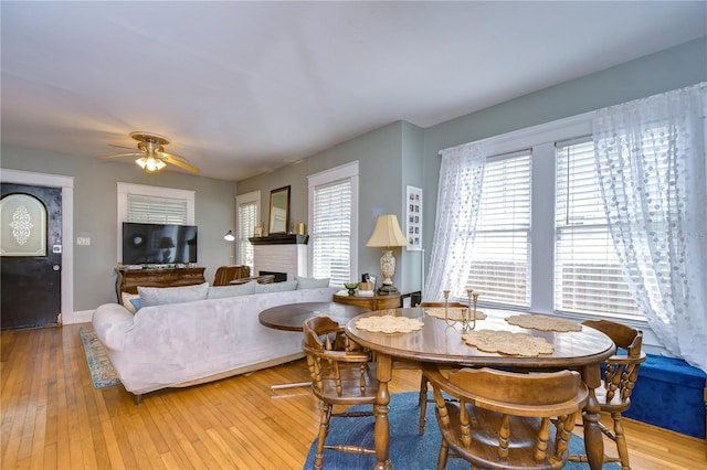 902 W Columbus Dr, Tampa, FL 33602 - dining space with healthy amount of natural light, light wood-style floors, a fireplace, and a ceiling fan