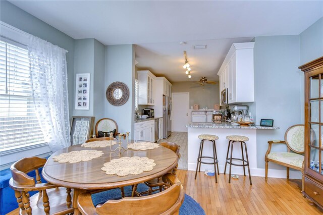 902 W Columbus Dr, Tampa, FL 33602 - dining room featuring healthy amount of natural light, light wood-style flooring, track lighting, and a ceiling fan