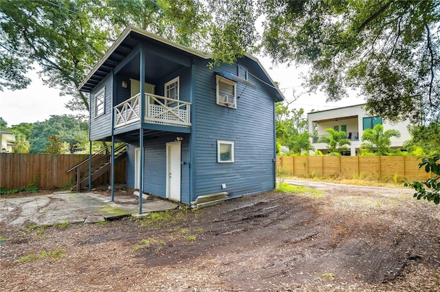 902 W Columbus Dr, Tampa, FL 33602 - rear view of property featuring a balcony, fence, and cooling unit