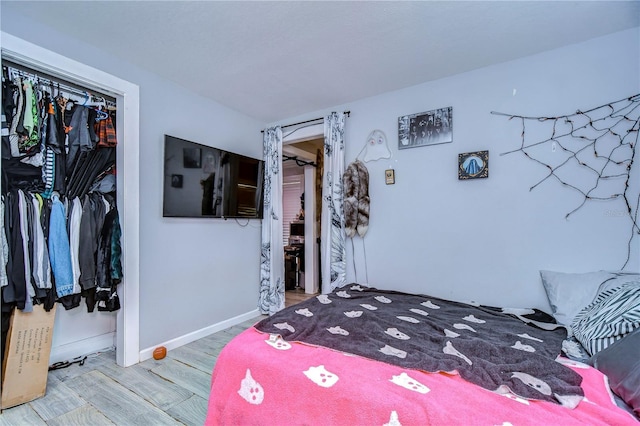 902 W Columbus Dr, Tampa, FL 33602 - bedroom featuring wood finished floors, a closet, and baseboards