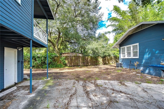 902 W Columbus Dr, Tampa, FL 33602 - view of yard featuring central air condition unit, fence, and a patio area