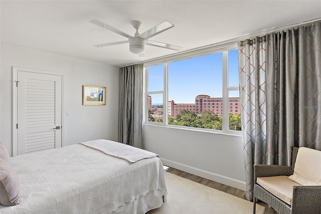 700 Beach Dr NE Unit 704, Saint Petersburg, FL 33701 - bedroom with wood finished floors, baseboards, and a ceiling fan
