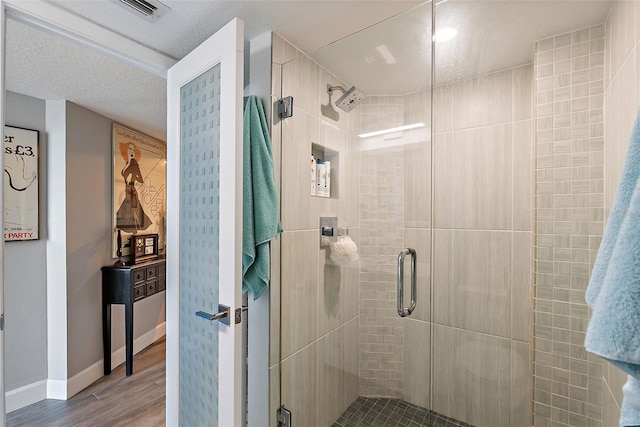700 Beach Dr NE Unit 704, Saint Petersburg, FL 33701 - full bath with wood finished floors, a shower stall, and baseboards