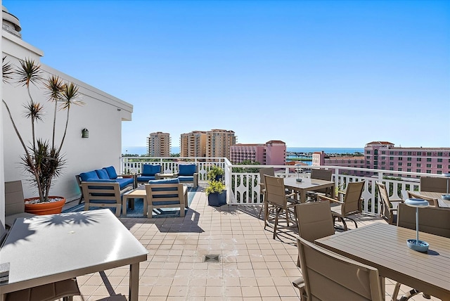 700 Beach Dr NE Unit 704, Saint Petersburg, FL 33701 - view of patio with outdoor lounge area, outdoor dining space, and a city view