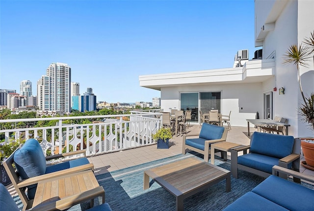 700 Beach Dr NE Unit 704, Saint Petersburg, FL 33701 - deck with outdoor lounge area, outdoor dining space, and a view of city