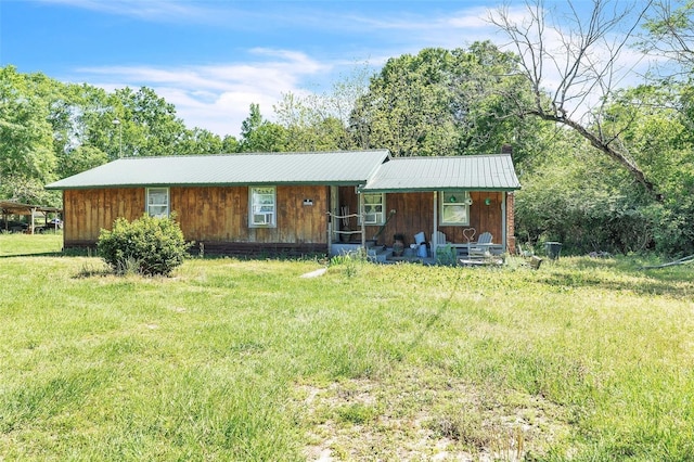 797 Hwy Unit 196, Cantonment, FL 32533 - view of front of house featuring covered porch, metal roof, a front yard, and a chimney