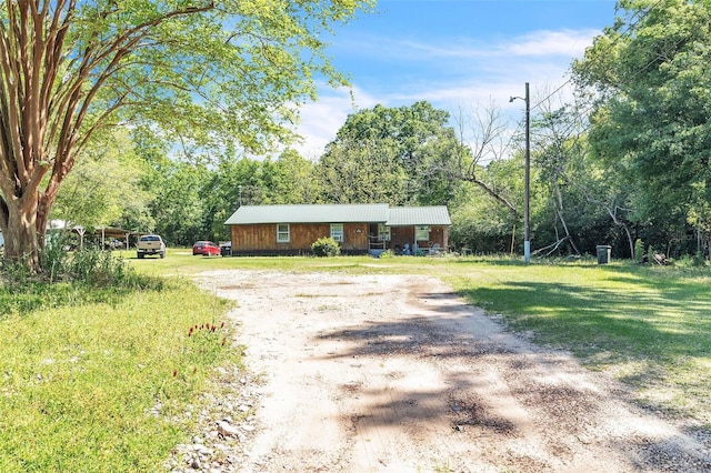 797 Hwy Unit 196, Cantonment, FL 32533 - view of front facade with dirt driveway, metal roof, and a front lawn