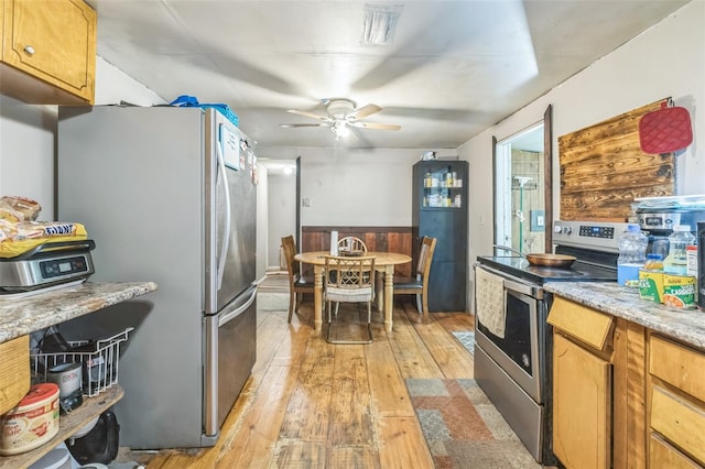 797 Hwy Unit 196, Cantonment, FL 32533 - kitchen with appliances with stainless steel finishes, light wood finished floors, a ceiling fan, and a wainscoted wall