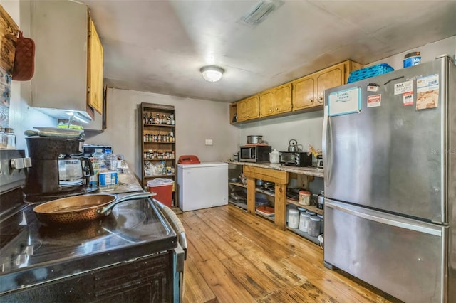797 Hwy Unit 196, Cantonment, FL 32533 - kitchen with stainless steel appliances, light countertops, and light wood-type flooring