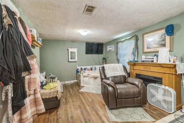 797 Hwy Unit 196, Cantonment, FL 32533 - living area featuring wood finished floors, a textured ceiling, and baseboards