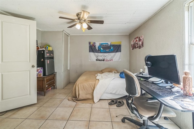797 Hwy Unit 196, Cantonment, FL 32533 - bedroom featuring freestanding refrigerator, tile patterned flooring, a desk, multiple windows, and a textured wall