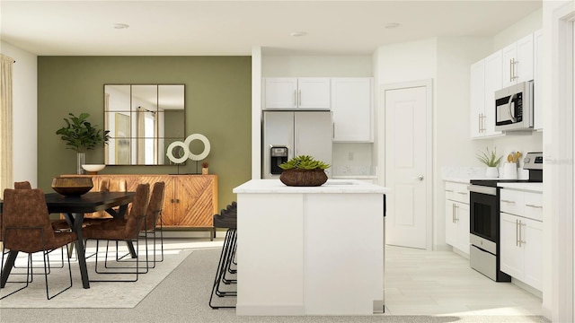 8625 Linked Dr, New Port Richey, FL 34655 - kitchen featuring stainless steel appliances, a kitchen island, white cabinets, and light countertops