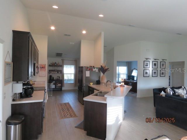 206 Samantha Ave, Auburndale, FL 33823 - kitchen with a sink, plenty of natural light, open floor plan, light countertops, and lofted ceiling