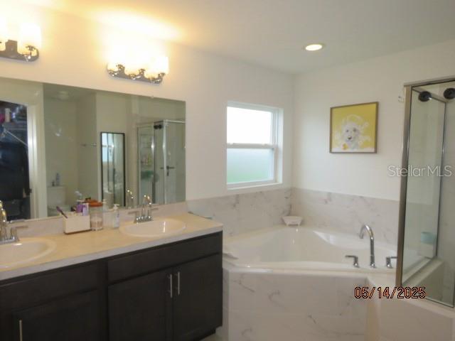 206 Samantha Ave, Auburndale, FL 33823 - full bath with a stall shower, a garden tub, and double vanity