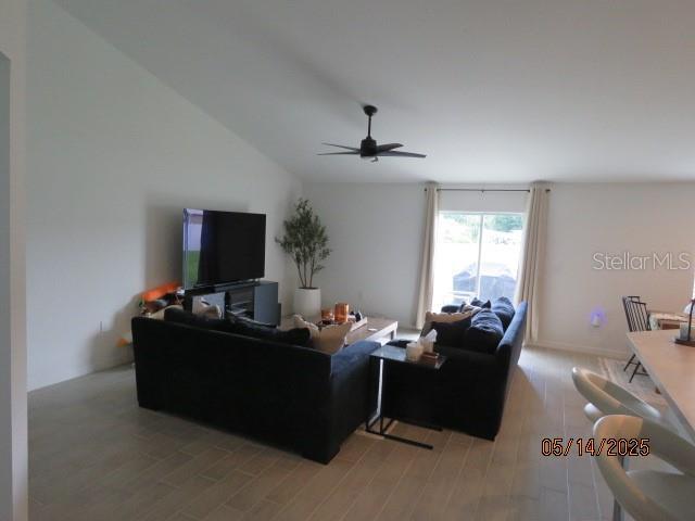 206 Samantha Ave, Auburndale, FL 33823 - living room featuring a ceiling fan, light wood finished floors, and lofted ceiling