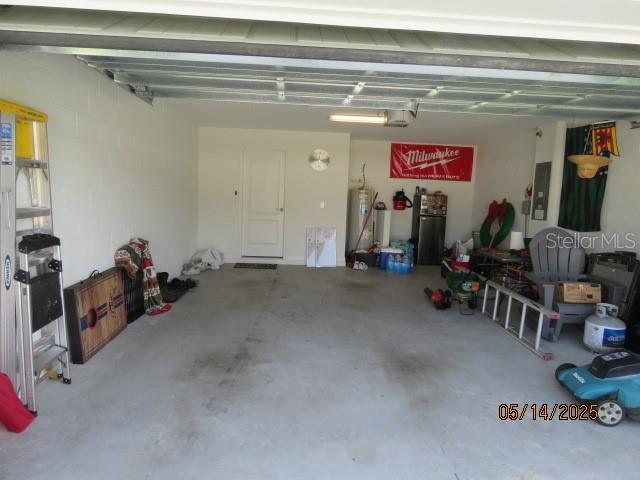 206 Samantha Ave, Auburndale, FL 33823 - garage with water heater, a garage door opener, and electric panel