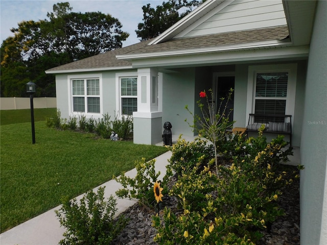 206 Samantha Ave, Auburndale, FL 33823 - property entrance with a shingled roof, covered porch, and stucco siding