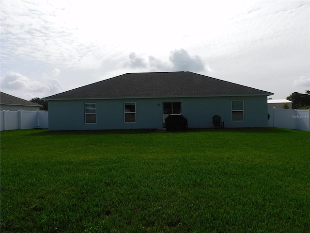 206 Samantha Ave, Auburndale, FL 33823 - back of property with a fenced backyard and stucco siding