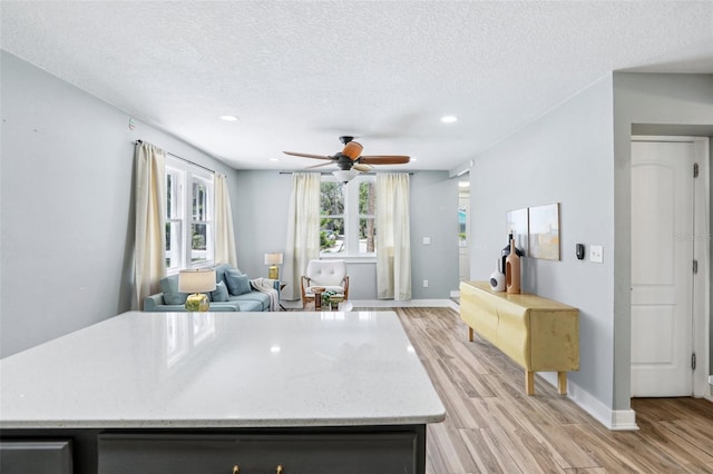 5632 Indiana Ave, New Port Richey, FL 34652 - kitchen featuring light wood finished floors, a ceiling fan, recessed lighting, a textured ceiling, and baseboards