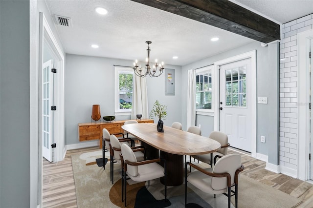 5632 Indiana Ave, New Port Richey, FL 34652 - dining area featuring light wood-style floors, a chandelier, baseboards, recessed lighting, and a textured ceiling