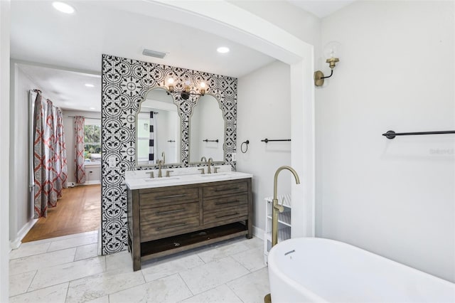 5632 Indiana Ave, New Port Richey, FL 34652 - full bathroom featuring double vanity, a soaking tub, recessed lighting, and baseboards