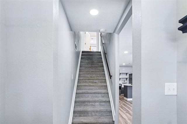 5632 Indiana Ave, New Port Richey, FL 34652 - stairs featuring wood finished floors, baseboards, and recessed lighting