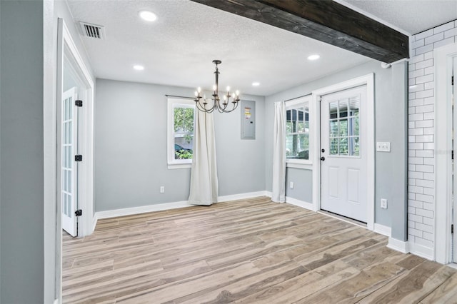 5632 Indiana Ave, New Port Richey, FL 34652 - unfurnished dining area with light wood-style floors, a chandelier, baseboards, a textured ceiling, and recessed lighting