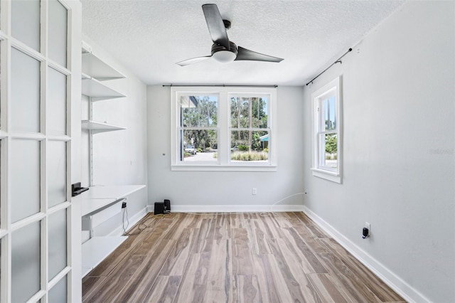 5632 Indiana Ave, New Port Richey, FL 34652 - interior space with wood finished floors, ceiling fan, a textured ceiling, and baseboards