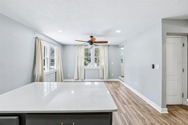 5632 Indiana Ave, New Port Richey, FL 34652 - kitchen featuring light wood-style flooring, ceiling fan, a textured ceiling, recessed lighting, and baseboards