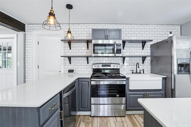 5632 Indiana Ave, New Port Richey, FL 34652 - kitchen featuring open shelves, appliances with stainless steel finishes, a sink, and a peninsula