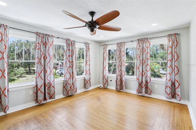 5632 Indiana Ave, New Port Richey, FL 34652 - spare room with a ceiling fan, hardwood / wood-style floors, healthy amount of natural light, a textured ceiling, and recessed lighting