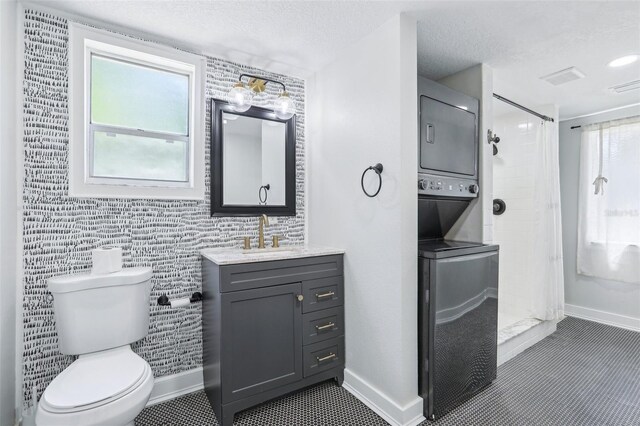 5632 Indiana Ave, New Port Richey, FL 34652 - full bath with stacked washer and clothes dryer, baseboards, toilet, and a textured ceiling