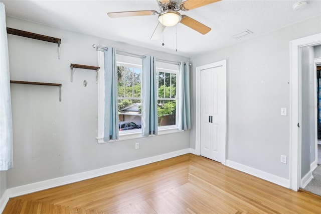 5632 Indiana Ave, New Port Richey, FL 34652 - unfurnished bedroom featuring baseboards, wood finished floors, a closet, and a ceiling fan