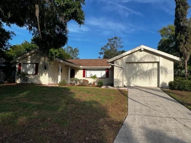 12415 Stagecoach Ln, Hudson, FL 34667 - single story home with an attached garage, concrete driveway, and a front lawn