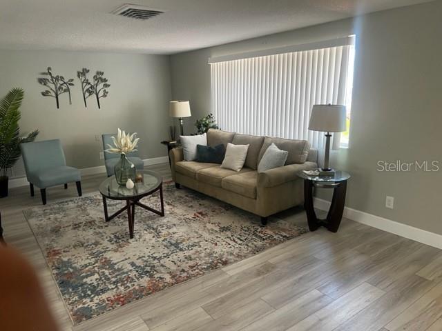 12415 Stagecoach Ln, Hudson, FL 34667 - living area featuring wood finished floors and baseboards