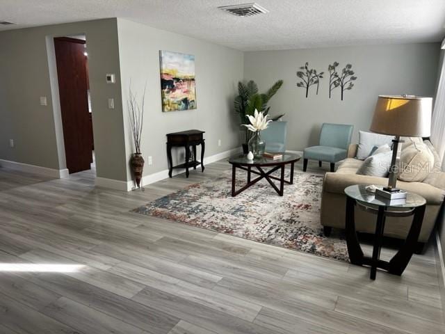 12415 Stagecoach Ln, Hudson, FL 34667 - living area with wood finished floors, a textured ceiling, and baseboards