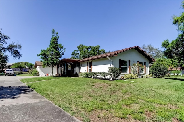 2380 Shelly Dr Unit B, Palm Harbor, FL 34684 - single story home featuring stucco siding, a front yard, and concrete driveway