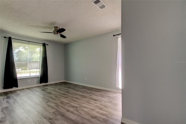 2380 Shelly Dr Unit B, Palm Harbor, FL 34684 - unfurnished room with ceiling fan, a textured ceiling, wood finished floors, and baseboards