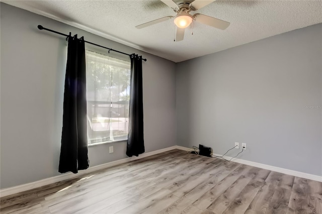 2380 Shelly Dr Unit B, Palm Harbor, FL 34684 - empty room featuring light wood finished floors, a textured ceiling, ceiling fan, and baseboards
