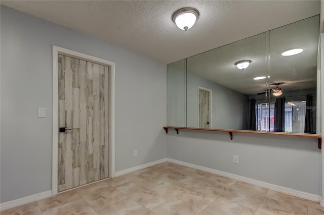 2380 Shelly Dr Unit B, Palm Harbor, FL 34684 - tiled empty room featuring a textured ceiling and baseboards