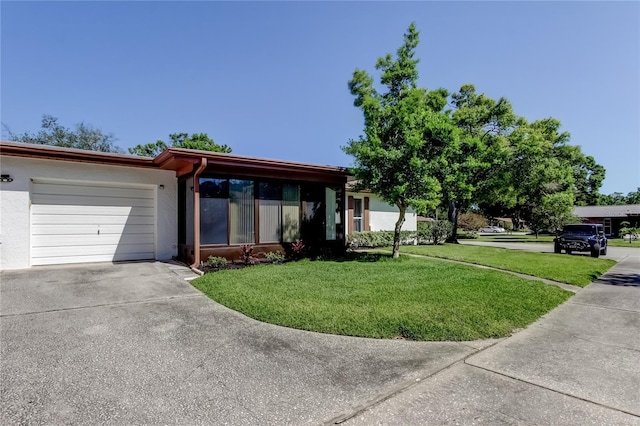 2380 Shelly Dr Unit B, Palm Harbor, FL 34684 - view of front facade featuring an attached garage, driveway, a front lawn, and stucco siding