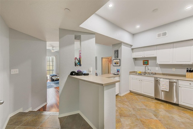 402 S Armenia Ave Unit 139A, Tampa, FL 33609 - kitchen featuring stainless steel dishwasher, a sink, a peninsula, white cabinetry, and light countertops