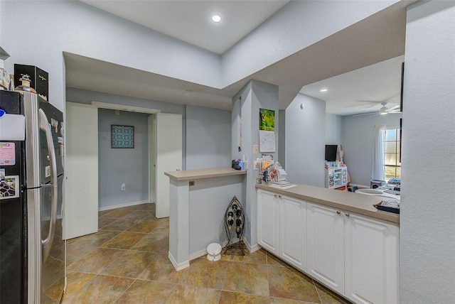 402 S Armenia Ave Unit 139A, Tampa, FL 33609 - kitchen featuring freestanding refrigerator, stone finish floors, white cabinets, a ceiling fan, and baseboards