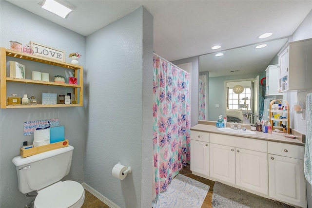 402 S Armenia Ave Unit 139A, Tampa, FL 33609 - full bathroom featuring toilet, vanity, a textured wall, wood finished floors, and recessed lighting