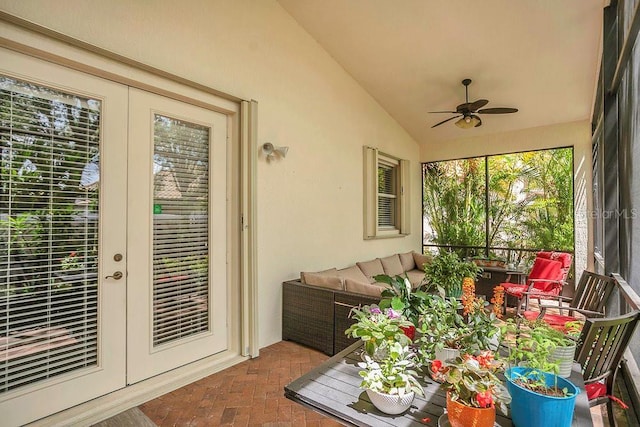 sunroom with french doors, brick floors, and vaulted ceiling