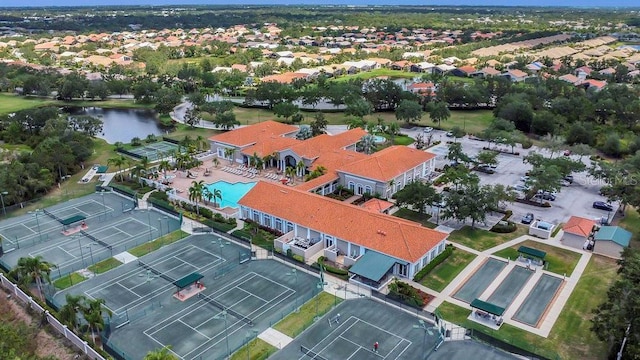 drone / aerial view of a pool and a nearby body of water