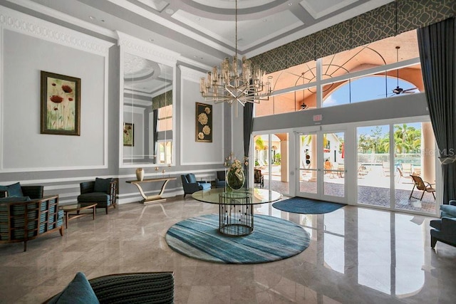 common area featuring a high ceiling, a decorative wall, wainscoting, and coffered ceiling