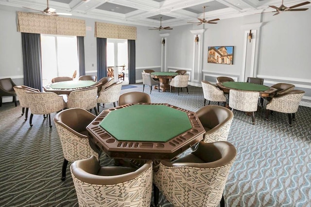 dining room featuring carpet floors, coffered ceiling, beamed ceiling, ceiling fan, and ornamental molding