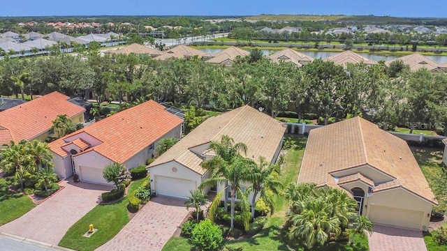 aerial view of residential area featuring a large body of water